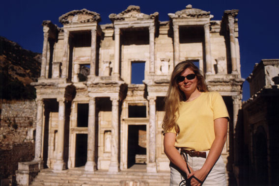 Susanne stands in front of the Library
