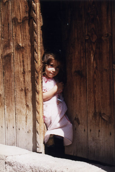 shy girl in a doorway