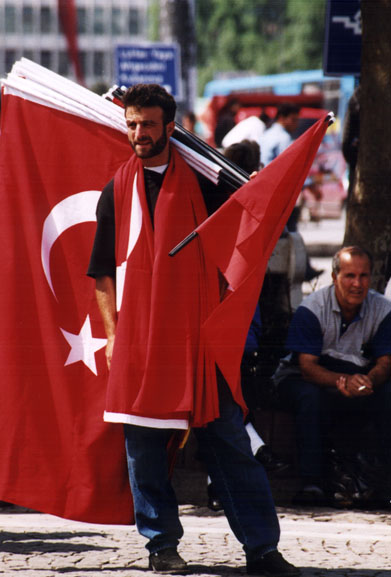young Turkish man with giant Turkish flags