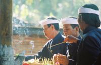 Men lighting incense inside the temple