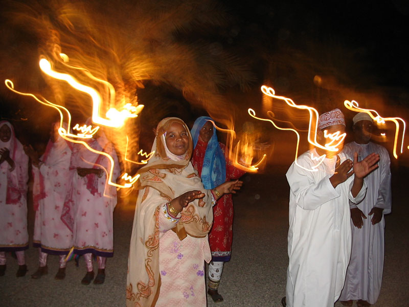 Singers performing at a nighttime feast in Muscat, Oman